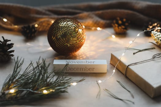 Christmas composition. Gift, fir tree branches, balls on craft paper background. Christmas, winter, new year concept. Flat lay, top view, copy space.