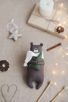 Christmas composition. Toy Teddy Bear, a gift, fir tree branches and decorations. Christmas, winter, new year concept. Flat lay, top view, copy space.