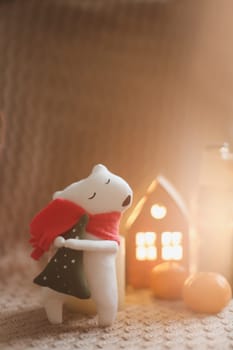 Christmas mood concept. Cozy composition with plaid, toy bear, tangerines and decorations