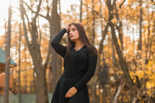 Close-up portrait of a young beautiful confident Indian Asian woman in fall outdoor. Happy and natural smiling female. Generation z and gen z youth