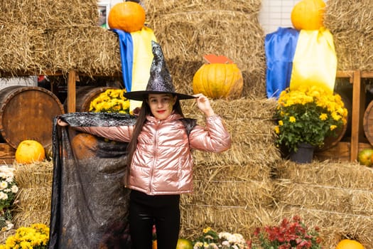 caucasian teenage girl in traditional witch or wizard hat, halloween outside costume, fancy dress party.