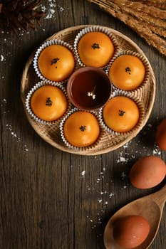 Traditional dessert for Chinese Mid-Autumn festival. Chinese pastry with stuffed salted yolk on wooden kitchen table.