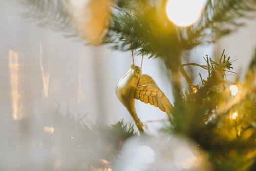 Christmas and New years eve Background. Close up of balls on christmas tree. Bokeh garlands in the background. New Year concept. Decorated Christmas tree on blurred, sparkling and fairy background