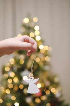 Christmas and New years eve Background. Close up of balls on christmas tree. Bokeh garlands in the background. New Year concept. Decorated Christmas tree on blurred, sparkling and fairy background