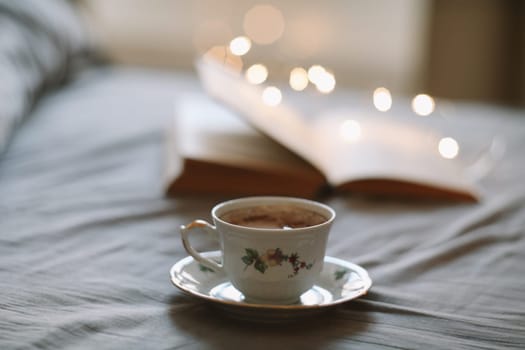 Spring still life. Breakfast in bed. White bedroom. Sweet home. Book and coffee cup