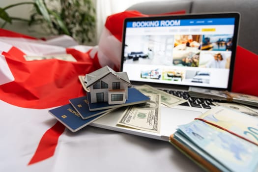 laptop with travel, money and canada flag.