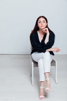 Portrait of beautiful woman in white pants and black shirt