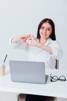 woman showing hands heart in office