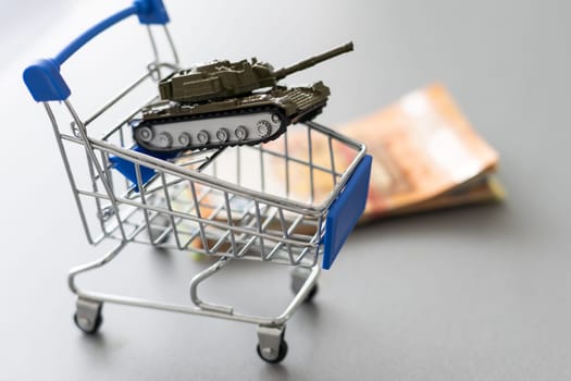 Toy panzer in shopping cart isolated on white background