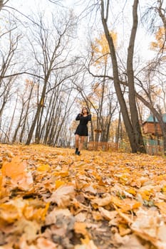 Close-up portrait of a young beautiful confident Indian Asian woman in fall outdoor. Happy and natural smiling female. Generation z and gen z youth