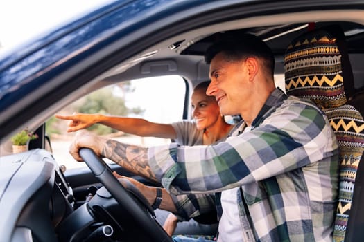 man and woman driving a camper van during a road trip, concept of couple adventure travel and active tourism in nature