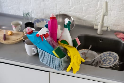 Basket with cleaning items on blurry spring background. High quality photo