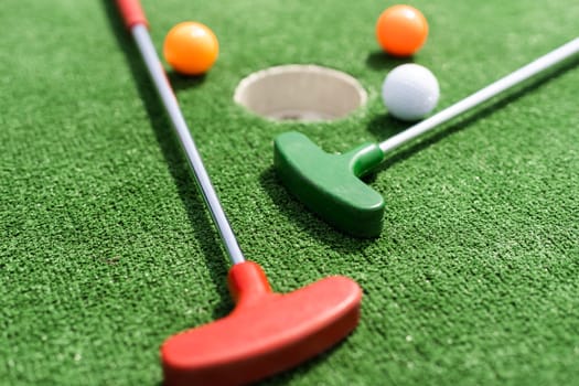 Mini-golf ball on artificial grass. Summer season game.