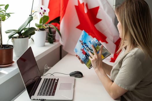 beautiful smiling woman covered in canadian flag looking at camera isolated on white. High quality photo