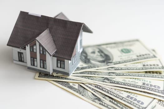 Concept of expenses for new home; small house, dollar paper money. High quality photo