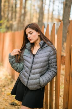 Close up portrait of pretty indian young woman enjoying warm autumn sunny day vacation outdoors. Generation z and gen z concept. Fall Season.