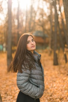 Close up portrait of pretty indian young woman enjoying warm autumn sunny day vacation outdoors. Generation z and gen z concept. Fall Season.