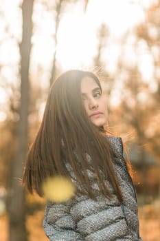 Close up portrait of pretty indian young woman enjoying warm autumn sunny day vacation outdoors. Generation z and gen z concept. Fall Season.