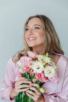woman in pink dress with bouquet of flowers