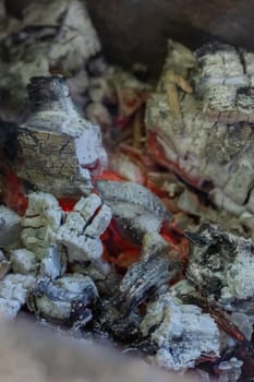 Burning coals in the old grill close up