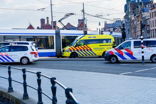 Emergency situation in Amsterdam city center as a pedestrian or cyclist has been hit. The ambulances and police vehicles are on the scene to provide assistance.