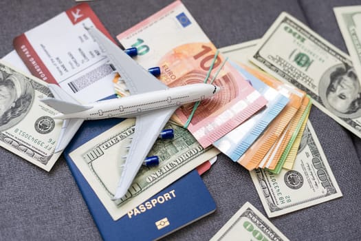 Air tickets, passports, money and toy plane on table. High quality photo