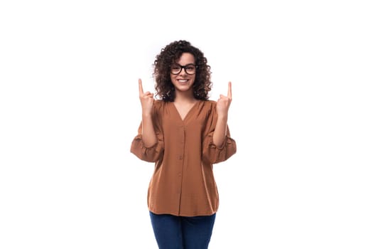 young positive cheerful slender woman with curls dressed in a brown blouse.