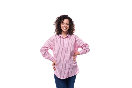 young caucasian bright woman with curly hairstyle wears stylish pink shirt.