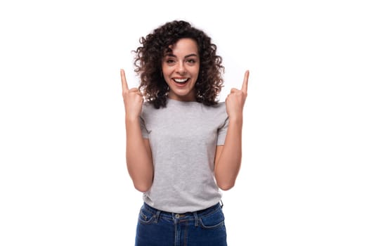 young slender brunette curly woman is dressed in a gray basic corporate color t-shirt. clothing identity and branding concept.