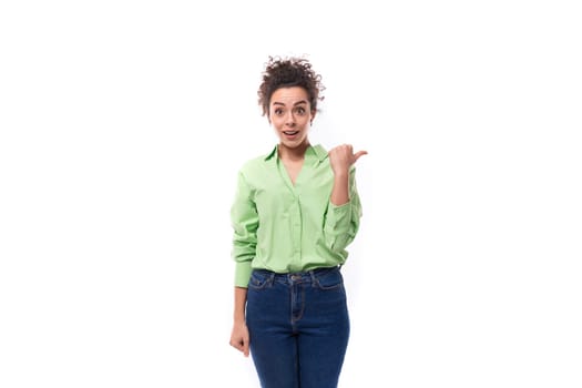 young well-groomed slender European brunette curly woman dressed in a green shirt on a white background.