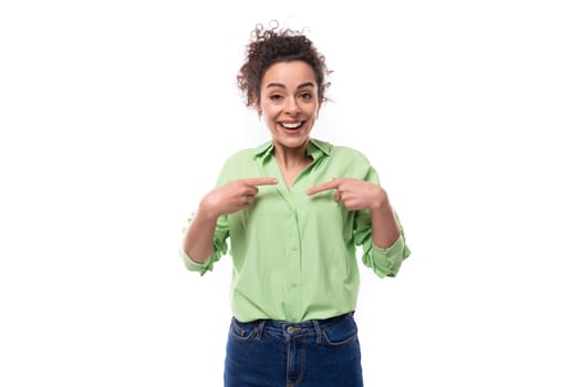 young smiling happy caucasian secretary woman with black curly hair tied in a ponytail on a white background with copy space.