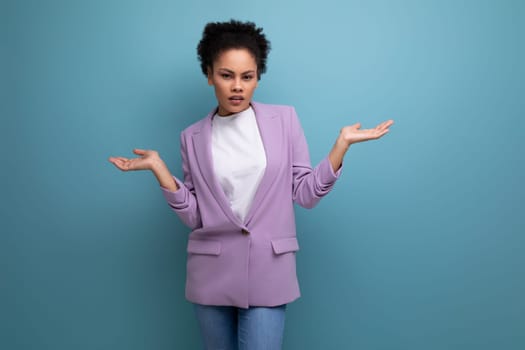 young pretty office woman dressed in a jacket doubts looking to the camera on the background with copy space.