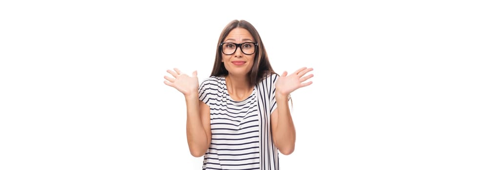 30 year old surprised brunette model woman dressed in a striped t-shirt on a wide white background with copy space.