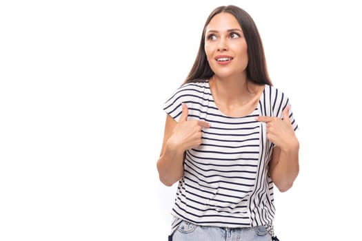 young positive pretty european brunette woman in a striped t-shirt on a white background with copy space.