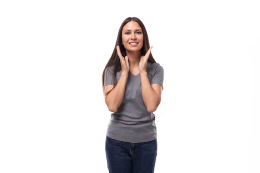 young slim brunette promoter woman with straight long hair dressed in a gray basic t-shirt with print mockup. uniform concept.