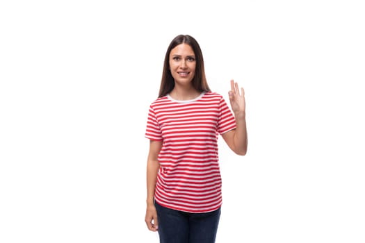 35 year old European lady in a red striped T-shirt shows a gesture that everything is ok.