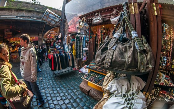 London, United Kingdom - March 31, 2007: Extreme wide angle (fisheye) photo of bags, clothes and other accessories on display at Camden Lock, famous flea market in UK capital.