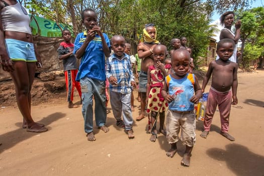 Malindi, Kenya - April 06, 2015: Curious African bare footed kids in local village. Even tough they look poor, this area is actually one of better developed thanks to tourism