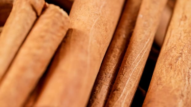 Close detail of cinnamon sticks, only small spot in focus, with blurred background.