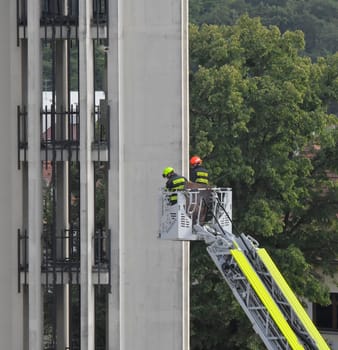 HUSTOPECE, CZECHIA - JULY 27, 2023: Firefighters at the church tower. Firefighter intervention at a high-rise building. Firefighters at the church tower.
