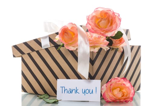 gift box with ribbons and beautiful roses inside, isolated on a white background.