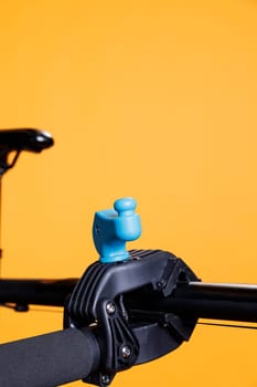 Photo focuses on the clamp used to secure the bicycle body while doing repairs. A wrecked bike is put on a workstand and seen in close-up. Service and upkeep for ideal cycling.
