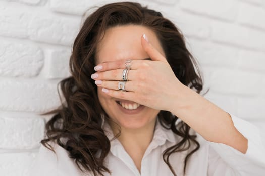 Women Jewelry concept. Woman's hands close up wearing rings and necklace modern accessories elegant lifestyle.