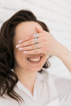 Women Jewelry concept. Woman's hands close up wearing rings and necklace modern accessories elegant lifestyle.