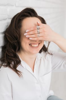 Women Jewelry concept. Woman's hands close up wearing rings and necklace modern accessories elegant lifestyle.