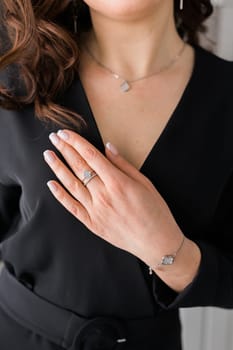 Close-up woman wearing beautiful luxury rings and bracelet. Handmade jewellery and accessories.