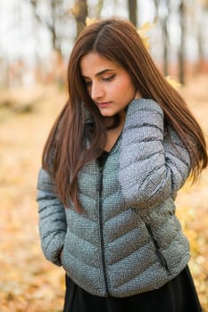 Close up portrait of pretty indian young woman enjoying warm autumn sunny day vacation outdoors. Generation z and gen z concept. Fall Season.