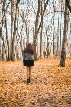 Close-up portrait of a young beautiful confident Indian Asian woman in fall outdoor. Happy and natural smiling female. Generation z and gen z youth