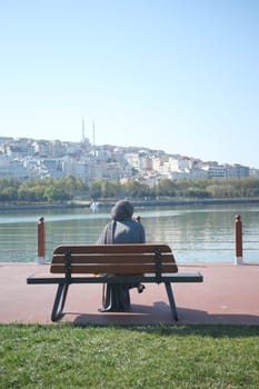 Unhappy girl sitting at bench