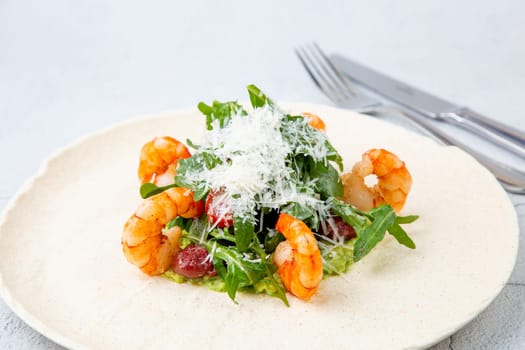 beautifully served shrimp with arugula and grated cheese